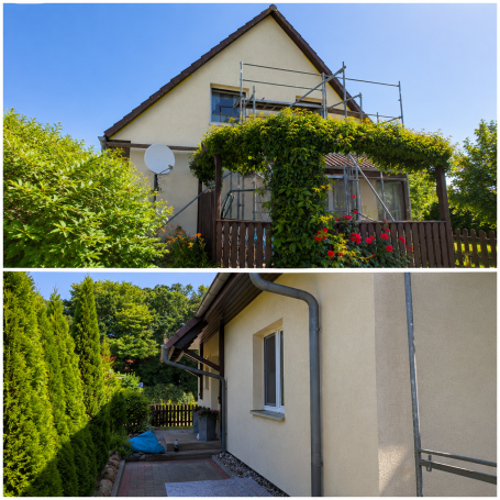 Zweifamilienhaus mit umgebendem Garten und Gerüst für Renovierungsarbeiten.