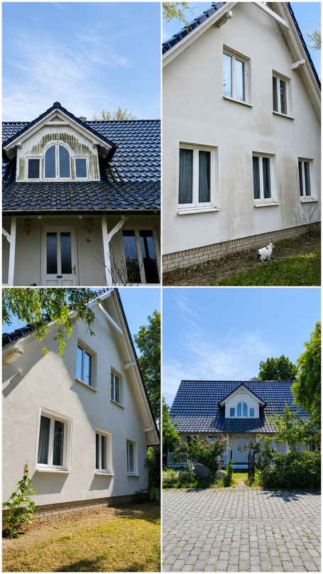 Fassade eines modernen Hauses mit Giebeldach und umgeben von Rasen und Bäumen.