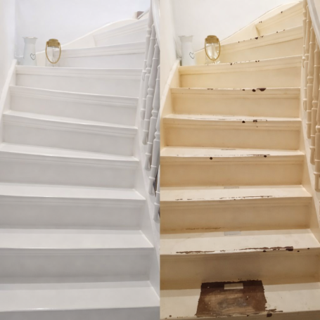 Eine Treppe mit einer Seite frisch gestrichen in Weiß und der anderen Seite unrenoviert.